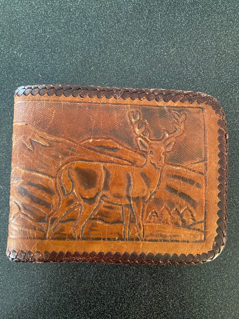 Vintage hand tooled brown leather bifold wallet with buck deer